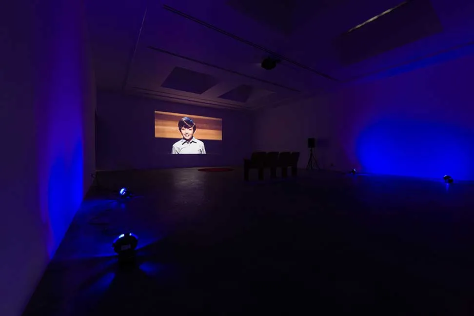 The Thought Leader, 2015. Single-channel video, theater seats, carpet, and four lights. Various Small Fires, Los Angeles (installation image)